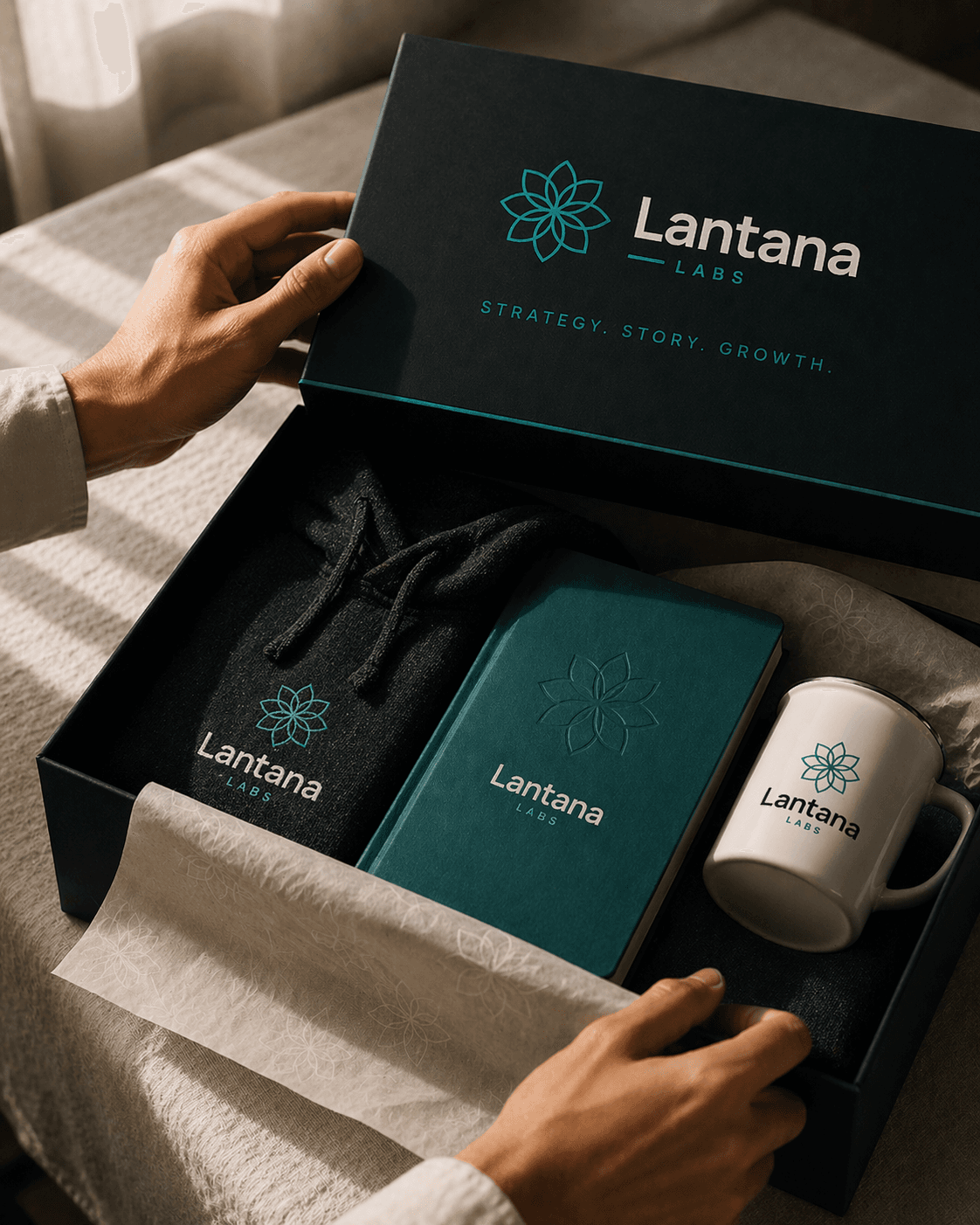 Hands opening a Lantana Labs branded gift box